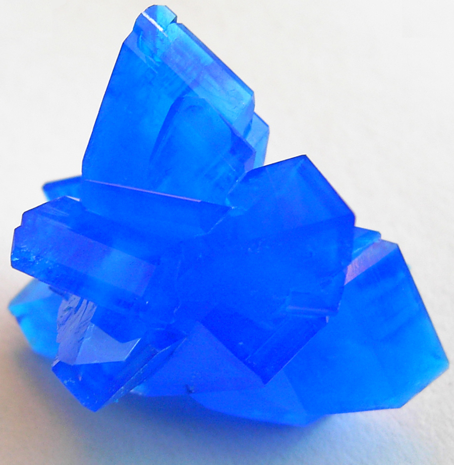 Blue copper(II) sulfate pentahydrate crystals with flat faces and sharp edges.